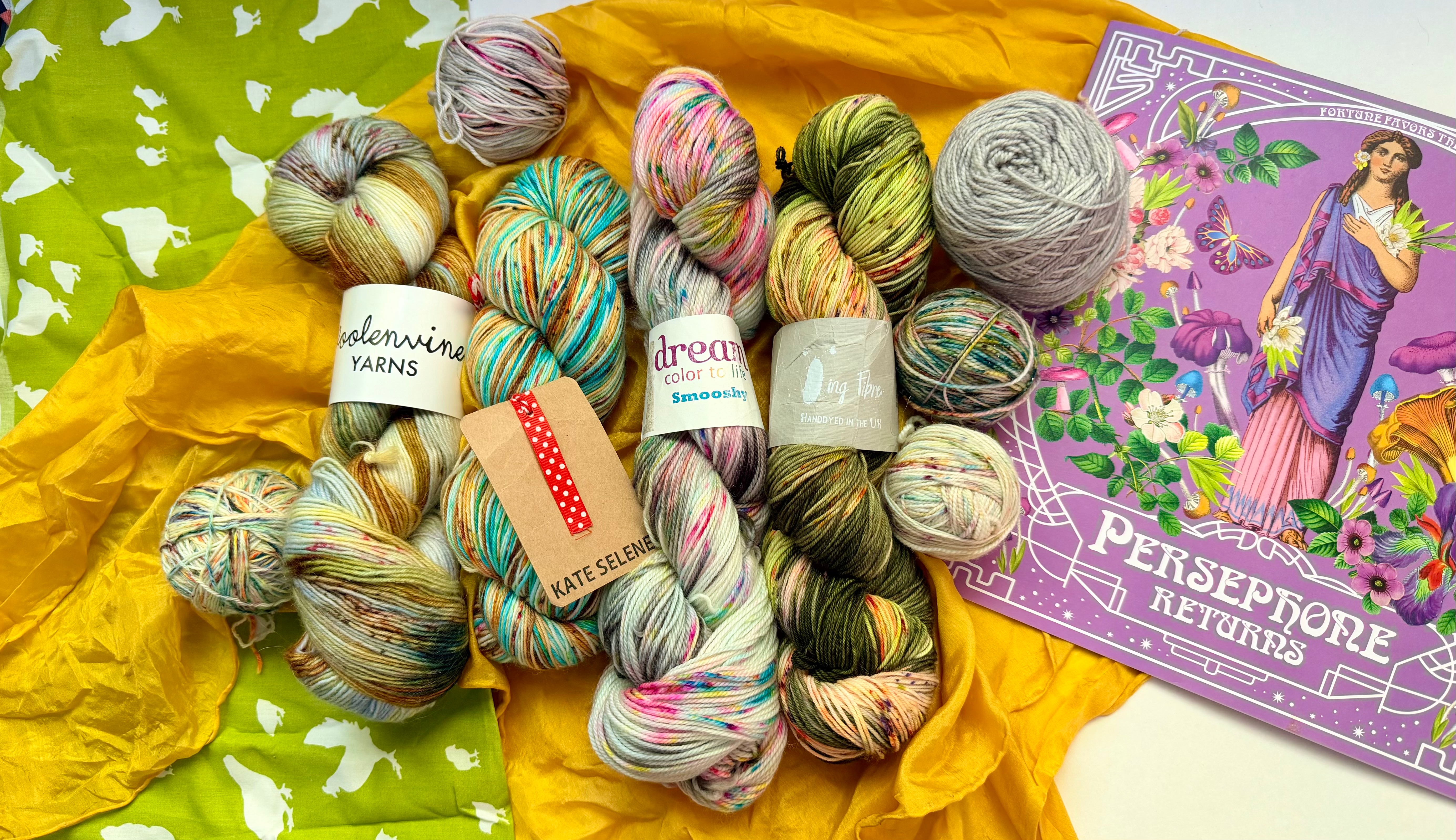 Indie Dyers — variegated hand-dyed skeins with dyer hangtags on a yellow surface